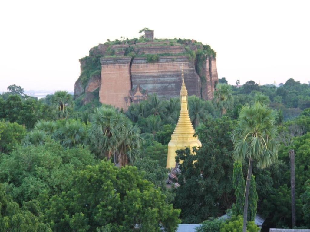 Huge cracks are visible on the structure from the earthquake of 23 March 1839. Like many large pagodas in Myanmar, a Pondaw paya or working model of the stupa can be seen nearby.