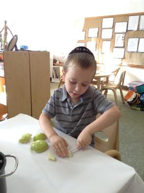I can peel, Emanuel shared when he saw the apples and peelers. He began to peel the apple.