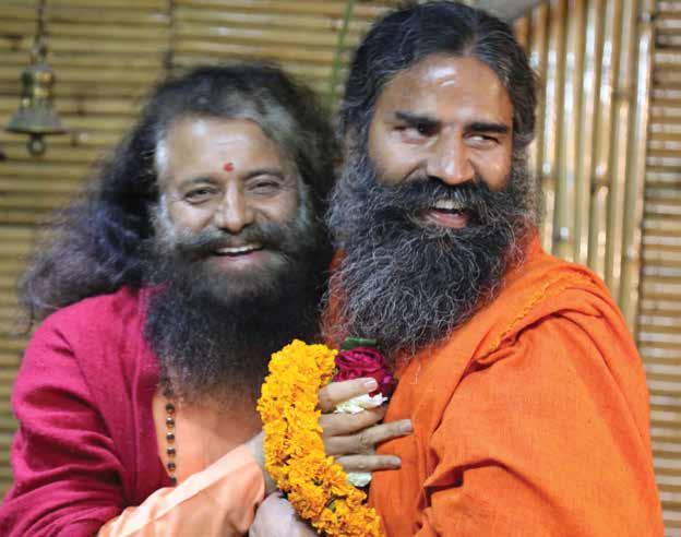 23 24 25 26 Yoga Guru Pujya Baba Ramdevji and Pujya Swamiji warmly greet each other with love and joy.