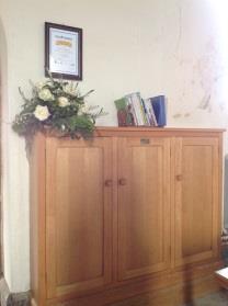 The book cupboard by the South door was given In loving memory of William Eccles OBE 1917-1989* The modern oak lectern was made and given in 1999 by Dermot Barton* onetime choirmaster at St John s.