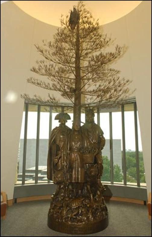 A bronze statue featuring Polly Cooper (center) holding a basket of corn, George Washington and Oneida Chief Oskanondohna can be seen at the Smithonian s National Museum of the American Indian in