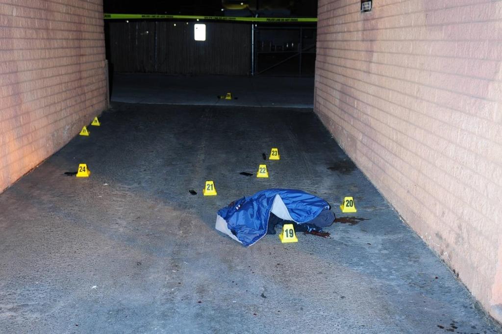 (The above picture depicts the exit breezeway at the motor lodge. At placard 19 is Bailey s clothes, marking the location where he came to rest after being shot.