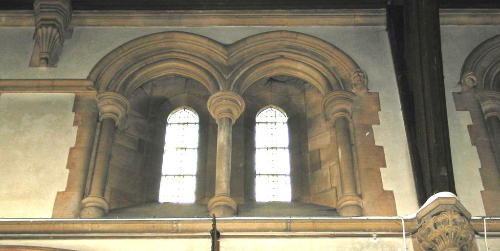 together. These struts are supported by carved stone corbels extended below as shafts. Fig. 10. Clerestory windows showing scoinson arch.