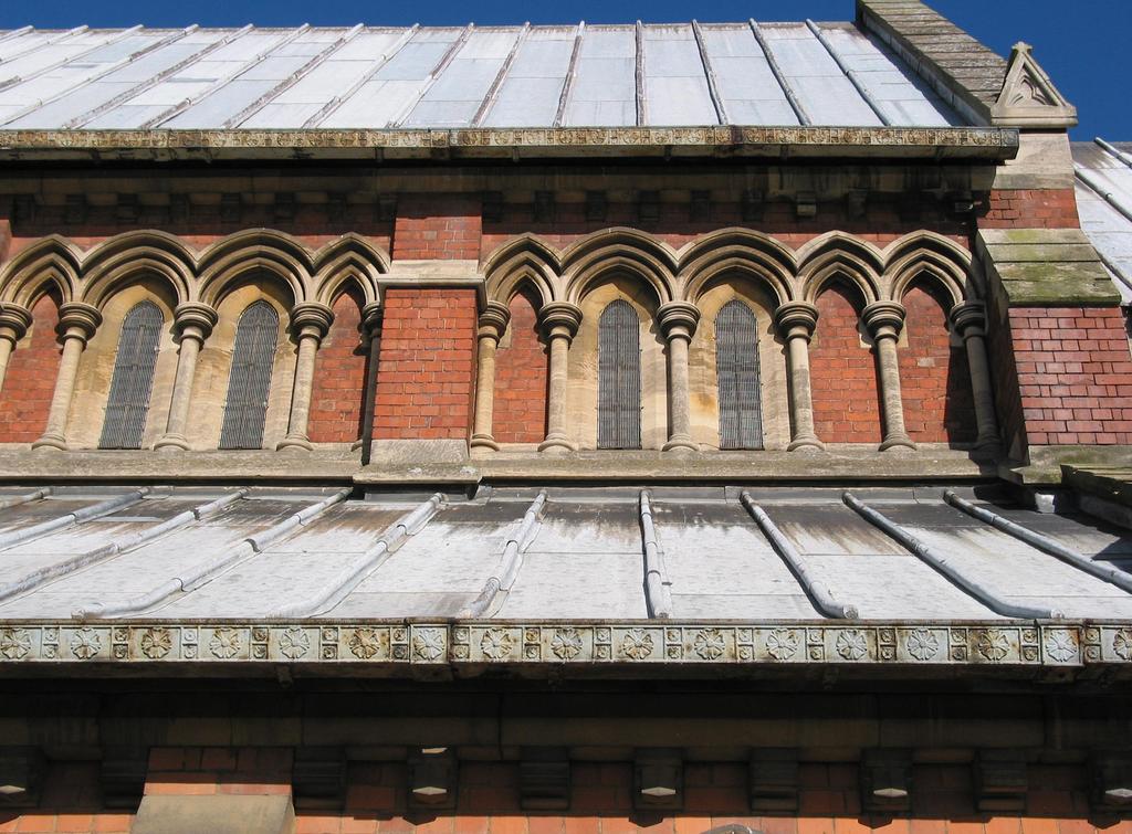 Fig. 4. Clerestory arcading and cast iron guttering. within blind arcading. The triple lancet west window is surmounted by two quatrefoil windows above the passageway.