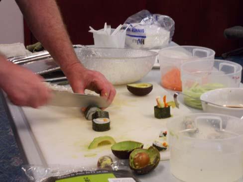 showing them proper techniques in making sushi during a food demonstration last month.