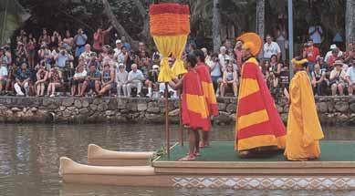 PHOTOGRAPH BY RICHARD M. ROMNEY In a canoe pageant, performers represent the King of Hawaii and his entourage, welcoming guests to the Polynesian Cultural Center.