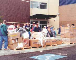 PHOTOGRAPH COURTESY OF LINDA CONLEE Members of a stake in Oregon help move supplies from a local high school to its new building.