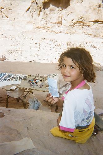 A child from Al Bdoul selling souvenirs in Petra (where her