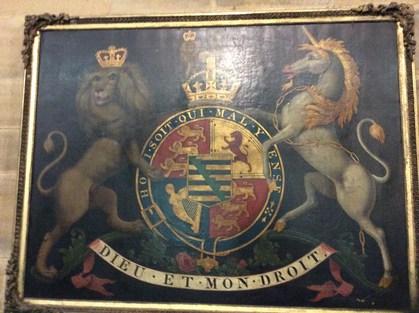 What is now in the new church: The Royal Coat of Arms which was mounted on the western gallery wall below the organ.