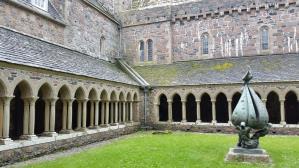 A cloister is a covered walk-way with colonnades arranged in a rectangle with open space in the middle.