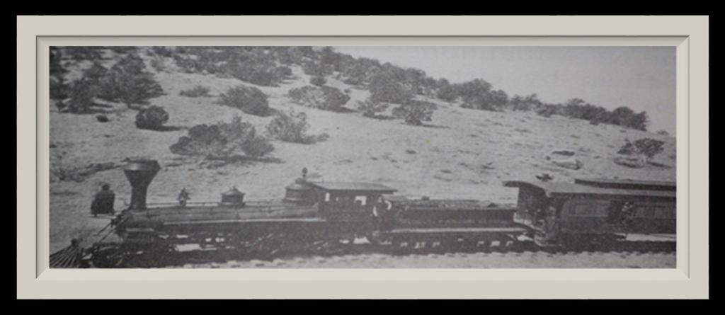 (This is a photograph of an old train dubbed "The Governor Frederick A. Tritle" passing through the town of Prescott in the Arizona Territory in 1887.