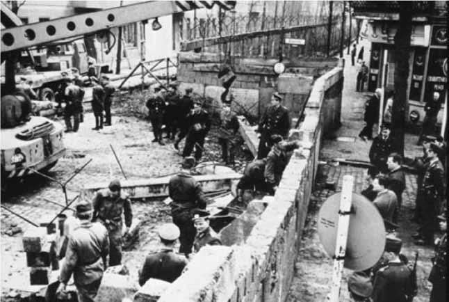U.S. National Archives August 1961: The Soviet-allied German Democratic Republic (East Germany) began building the Berlin Wall, dividing East Berlin from West Berlin.