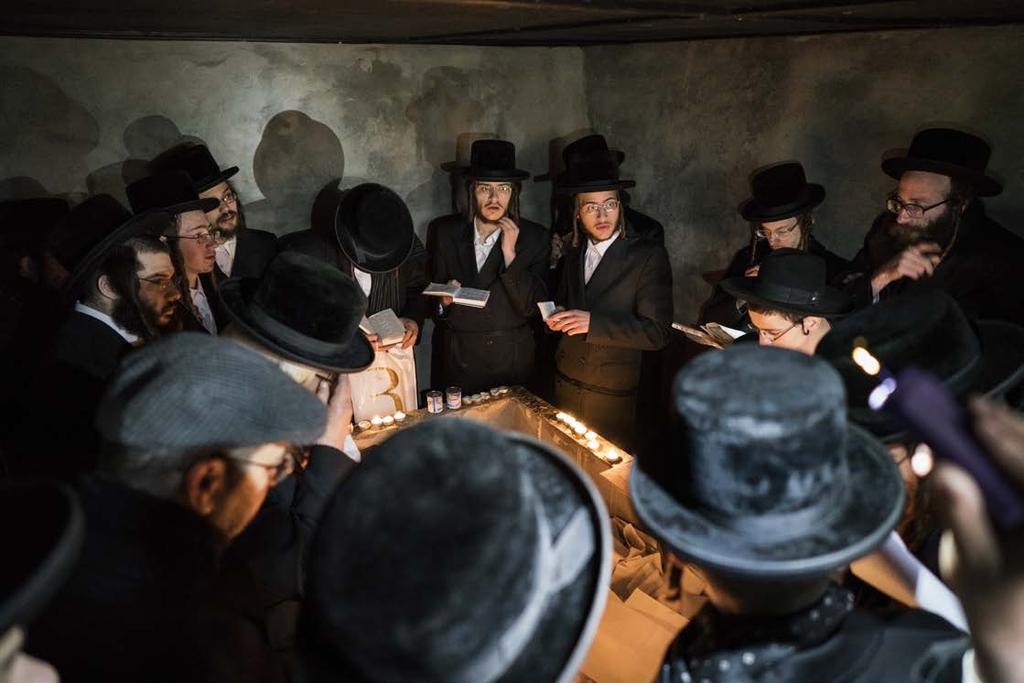 Hasidic Jews pray at the tomb of Rabbi Menachem Nochum Twersky. The tombs are located near a former school within the evacuated area of Chernobyl.