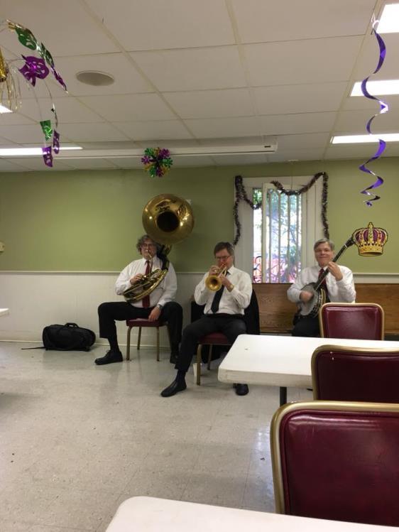 Mardi Gras Spirits (left) [Photograph from the St. George s, New Orleans, Facebook Page] The John Parker Trio entertained parade goers attending the St. George s Mardi Gras Spirits.