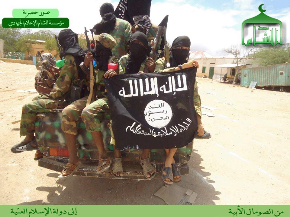 HSM fighters hold the ISIS banner with