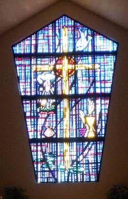 SOTG STAINED GLASS WINDOW The Trinity The Father: To the left of the cross is the open hand of God, giving all life and creation, the sun, the moon, and the stars, all creatures great and small, and