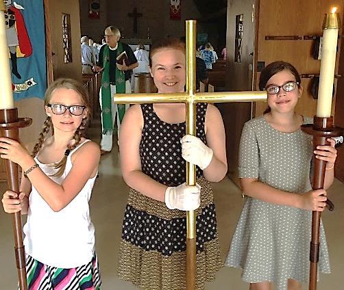 During the reading of the Psalm of the day, children who wish to participate in Summer Stories join the adult leaders at the front of the church and follow the cross to Sanders Hall.