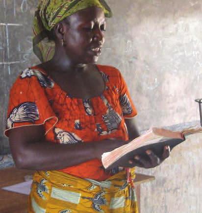 Elizabeth became literate and is now seen reading the second reading in the service at Kpalugu.