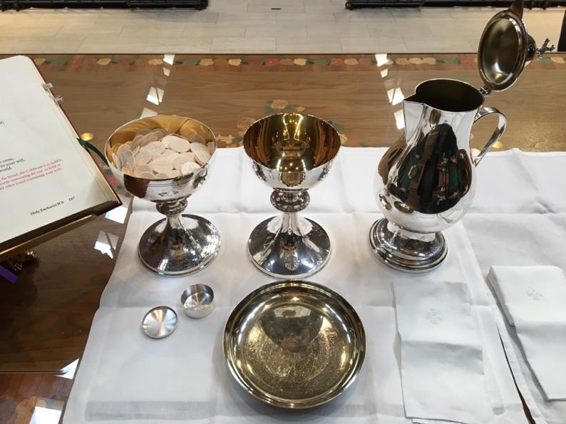 At the Offertory During the Offertory Anthem, the Deacon sets the Altar with the help of the First Server. a. Ciborium is opened and lid moved. b. Large flagon is opened and water is poured in it. c.