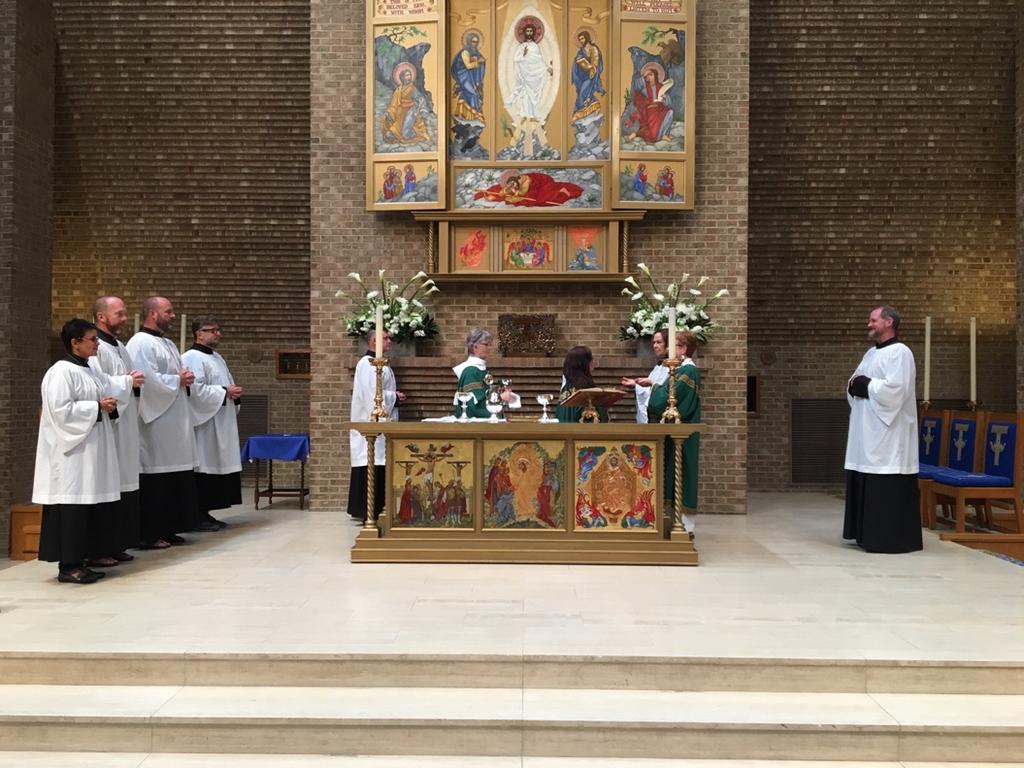 After receiving communion, the Emcee retrieves two additional chalices from Niche and brings to the Altar, waiting until the area is clear of all clergy and EMs before moving behind the Altar.