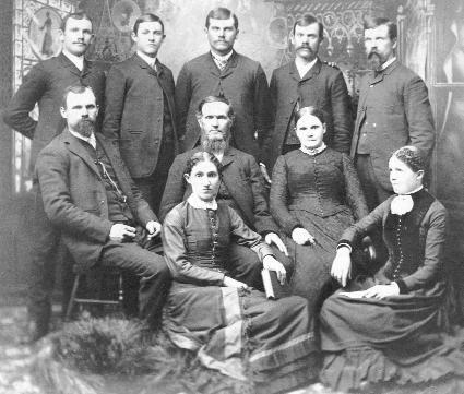 Portrait of the Reynolds family, Monmouth, Illinois. Richie Reynolds stands at back row, center, with John Jr. to his left. Patriarch John Reynolds Sr.