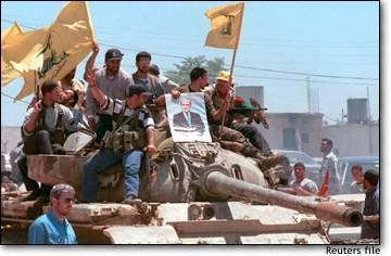 62 The bottom line: Hezbollah operatives brandishing flags of the organization and displaying the picture of the late Syrian president Hafez al-assad The massive and continuous support granted by