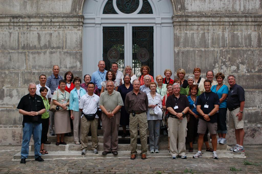 A tour group poses in front of the motherhouse of the Congregation of the Mission, Paris, France.