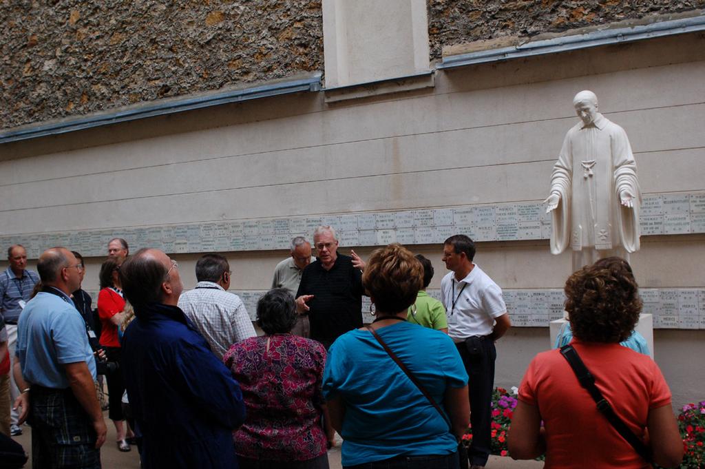 A group stops to listen as tour guide Rev. John Rybolt, C.M., explains the significance of a site.