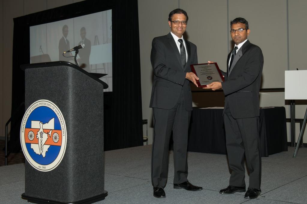 Scholarship award. Right Dr. Ravi Krishnan accepts his plaque from Dr.