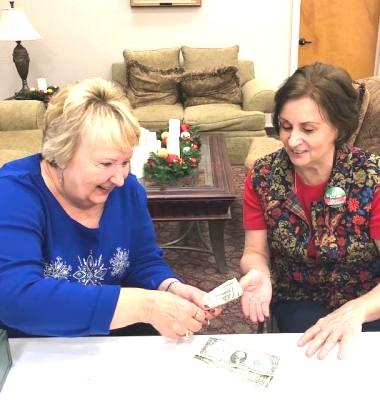 Carol Meyers found time to introduce Nancy Borden to becoming a cashier.