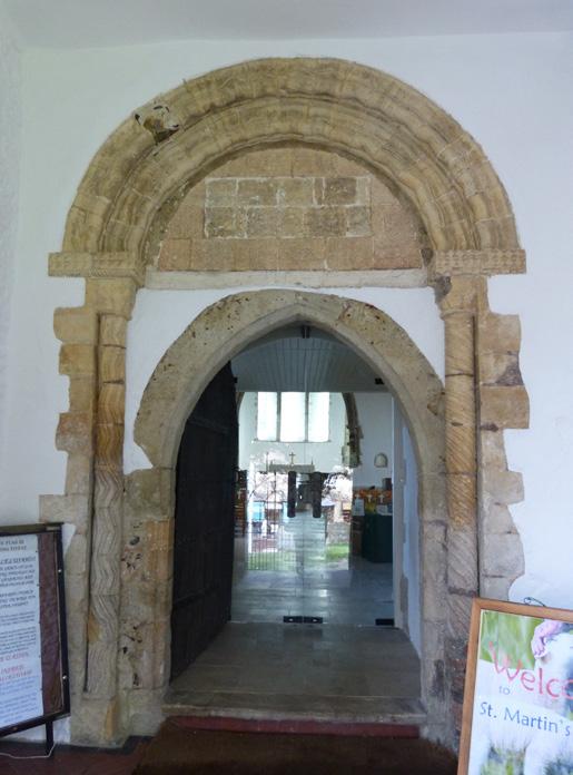 the 13th century with a later 16th century north aisle. There are traces of the earlier Norman church in the chancel windows and its semicircular apse.