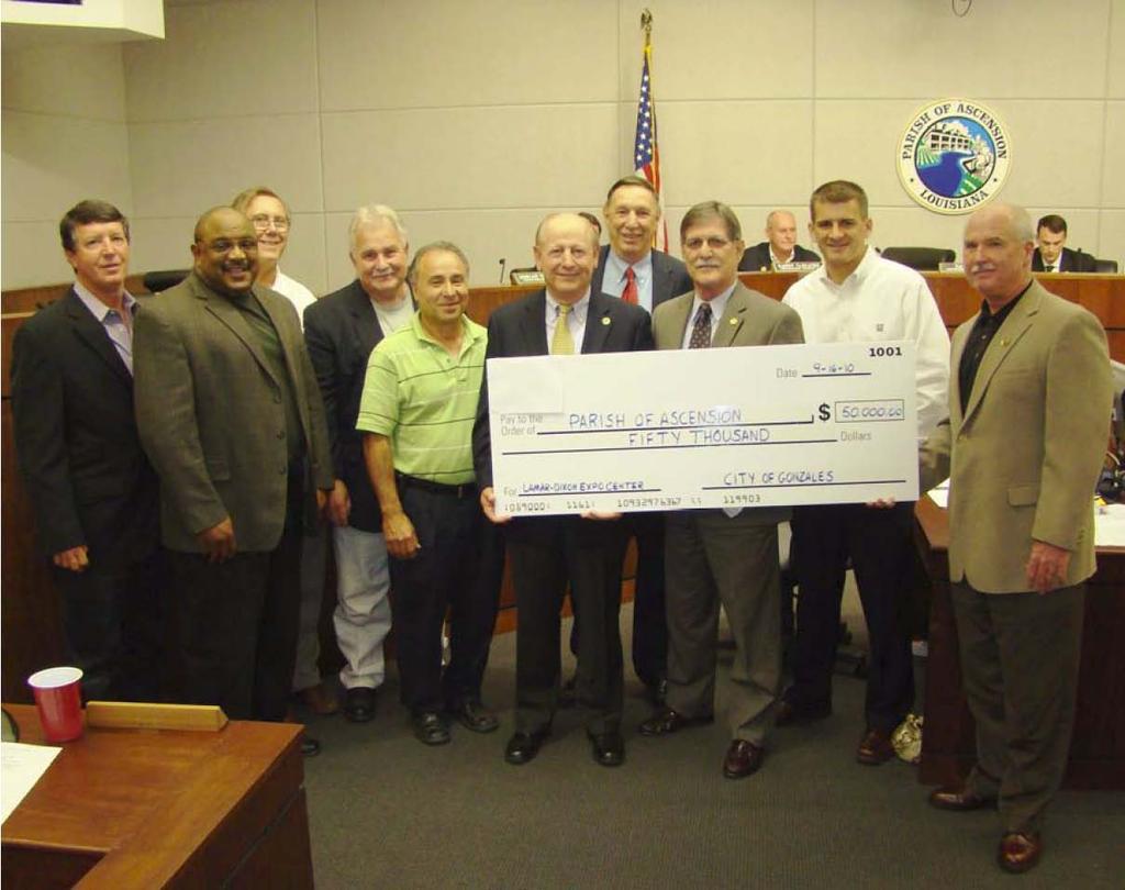 Council.091610 023 Officials from the City of Gonzales present a check for $50,000 to Ascension Parish officials at the Sept. 16 Parish Council meeting to fund the Lamar-Dixon Expo Center.