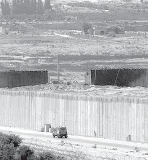 In a statement, the Venezuelan Foreign Ministry urged the interna- File photo shows an Israeli army vehicle driving near the cement fence separating Israel and the Gaza Strip.