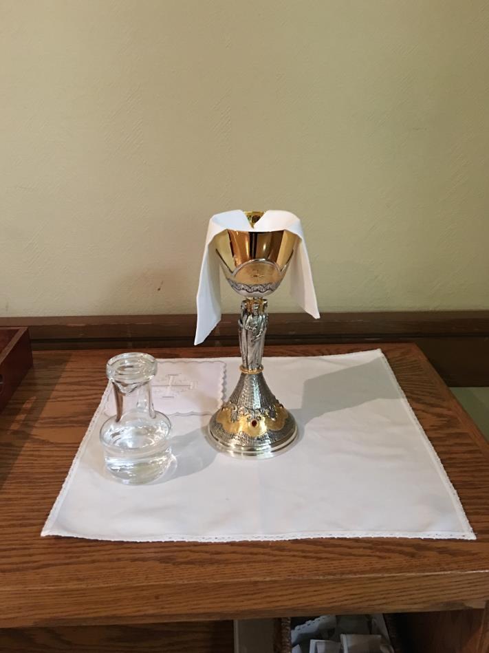 + The priest chalice in on the credence table on the floor. Do not take the square/hard pall (covering) to the altar. If it is on top of the priest chalice, remove it and leave it on the table.