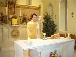 " Father Atli blesses the bread and wine during the mass.