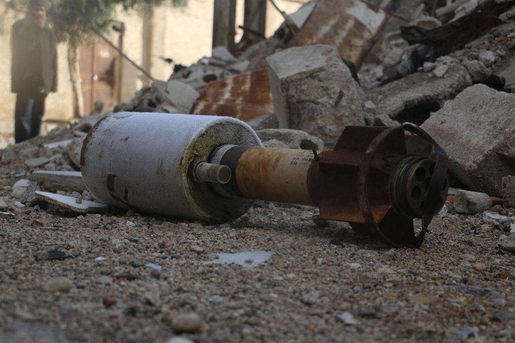The same munition as above, moved to the ground. Photo credit: Media activist from Duma (During an interviw with STJ's reporter). The location the photograph on the roof was taken is 33.572149, 36.