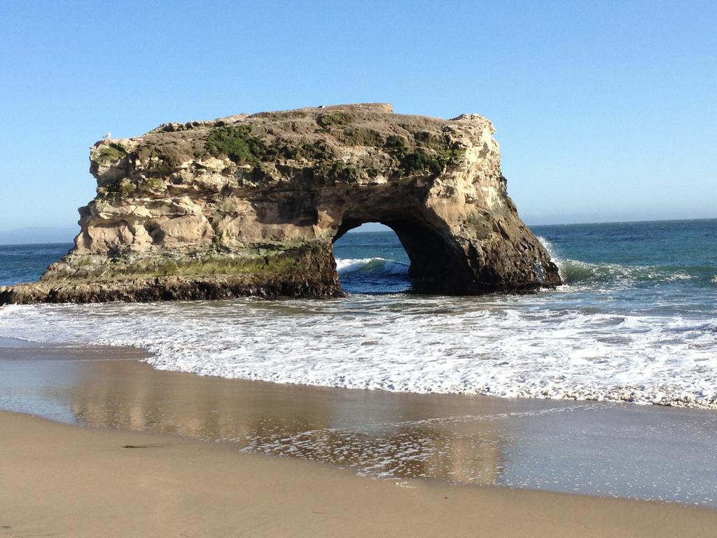 This is a stone portal at the Pacific Ocean by Santa Cruz just this spring. I was struck by its perfection, both rough and round. The power of the elements.