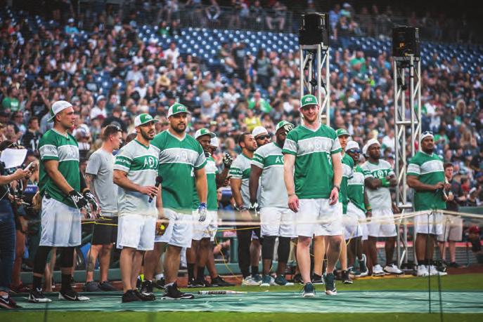 Several Philadelphia Eagles players on the field for a home run derby ahead of Carson Wentz's AO1