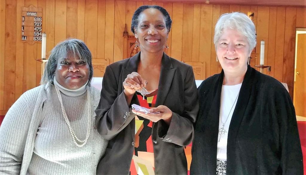 United Thank Offering Coordinator Honored. Yvette McMiller, center, shows the United Thank Offering Cross presented to her by St.