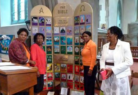This picture shows Tsholo, Tumelo, Kgomotso and Mary Jane looking at the URC Bible Triptych (which was on loan to St. Peter s for Petertide).