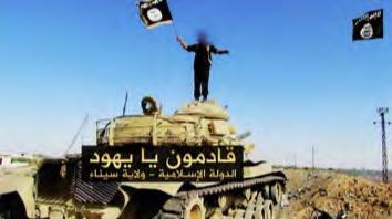 ISIS s threat to Israel: An operative of the organization waving the ISIS flag on a tank, with the caption: We are coming, O Jews.