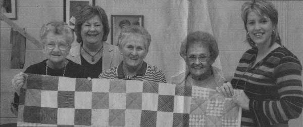 From left, in front, are Quilting Bees Mable Maddux, Olive Lee (Jernigan) Jared and Gerema Anderson; the winner and his wife, Willene; and in back, Quilting Bees Shirley Maynard and Beverly Johnson;