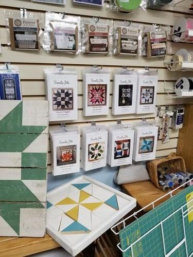 Check out the white, yellow and teal quilt block mosaic board. I LOVE it. the blocks are in a tray but can be lifted, turned and placed to make quilt blocks. Well I want it for my childcare.