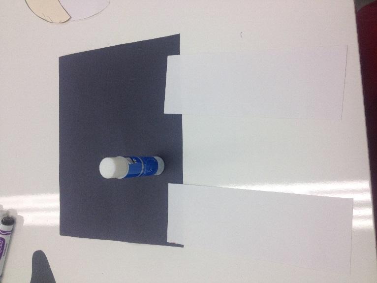3. Cut out the legs on a white sheet of construction paper using the template twice.