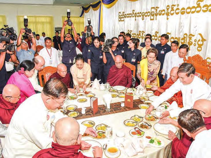 3 President U Win Myint and wife Daw Cho Cho offer Kathina robes to a monk at Sasana Maha Beikman, Uppatasanti Pagoda, in Nay Pyi Taw.