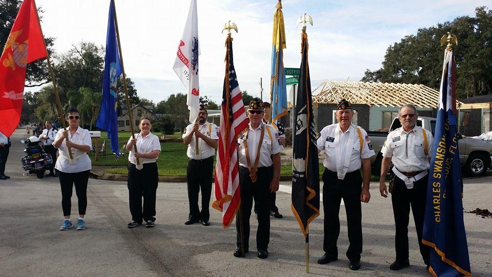 Members carrying Legion and American flags