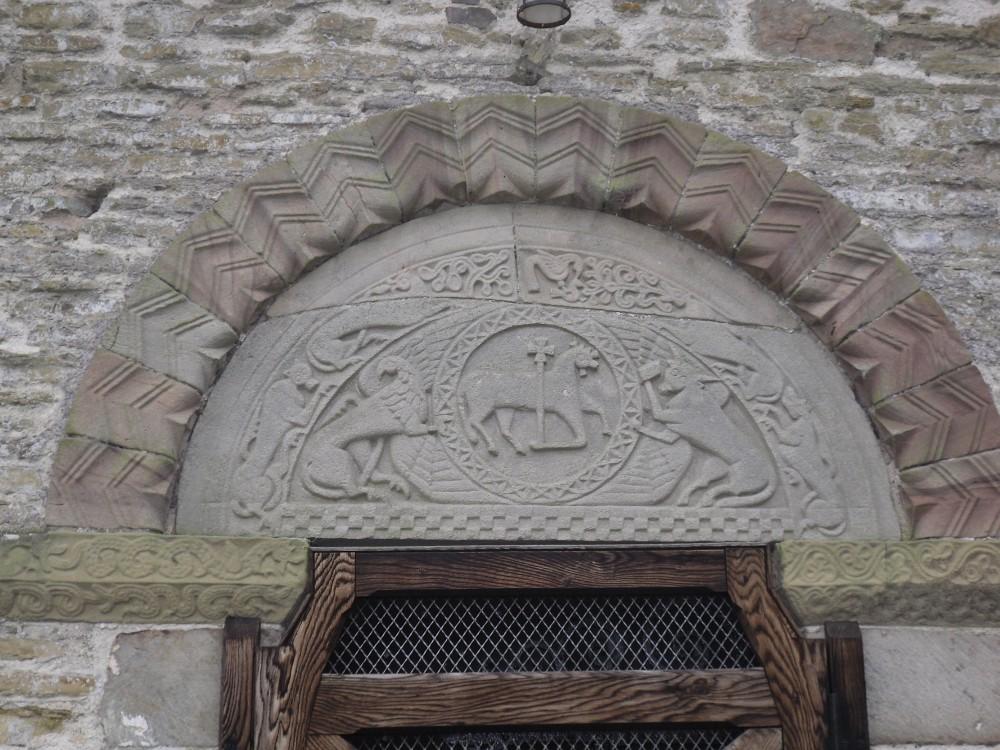 The relief carving of the Tympanum at Pipe Aston depicts the Lamb of God at the centre, with the eagle of