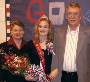 [to the left] Pastor Bill McClung and his wife, Janet, stand with their daughter, Beth, after Beth was named Homecoming Queen for Mountain View Christian School. Beth will graduate in the spring.