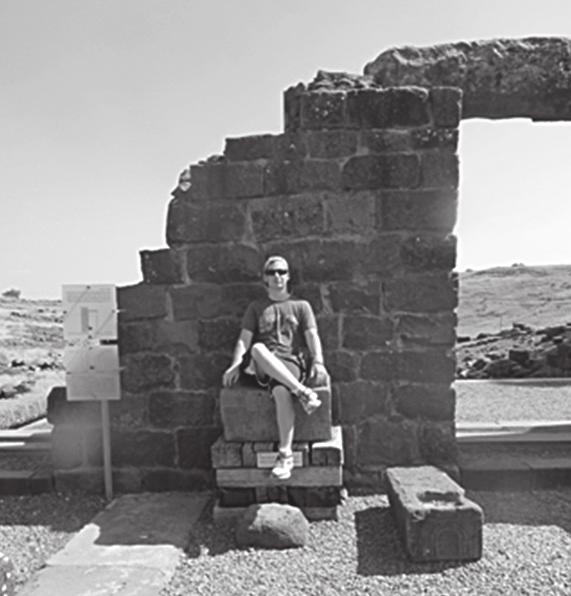 Zosh Simonson 16 sits in a replica of the Chair of Moses in Chorazim, Israel.
