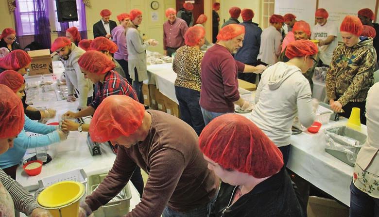 COVER FEATURE The group from One Connection Haverhill join others from the community to package meals for people in need.